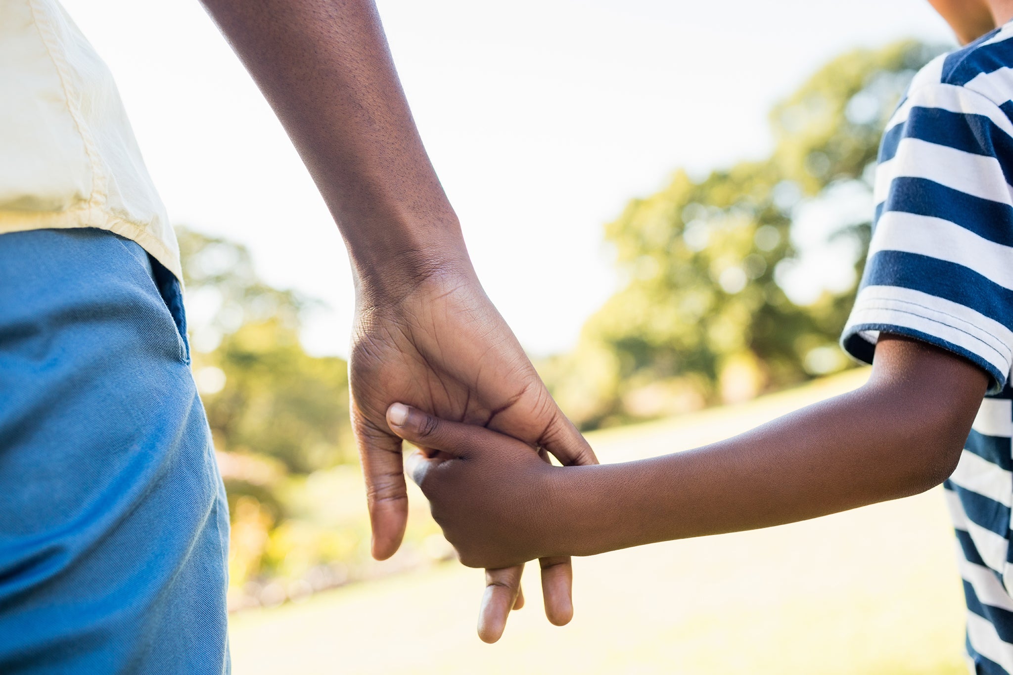 Man and chid holding hands
