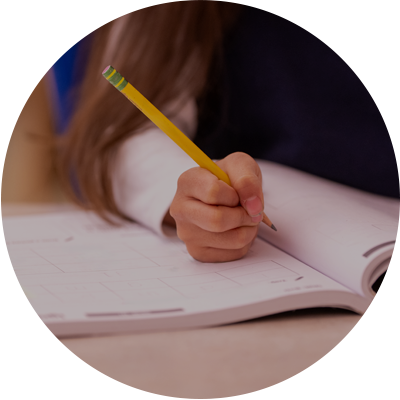 Person writing in a notebook with a yellow pencil