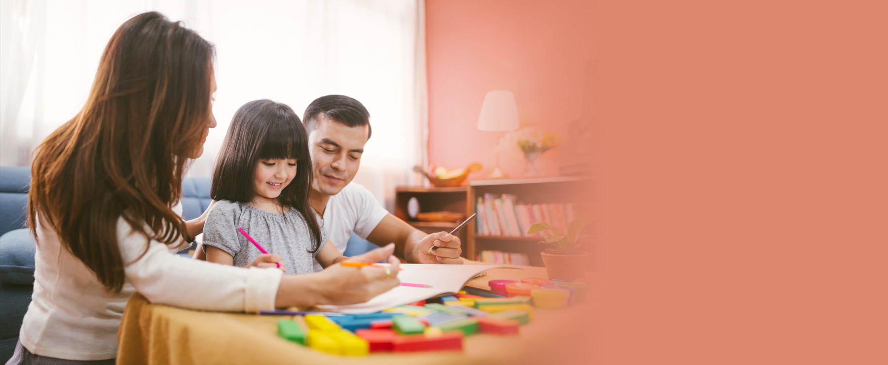 Mom and dad helping preschool-age daughter with schoolwork